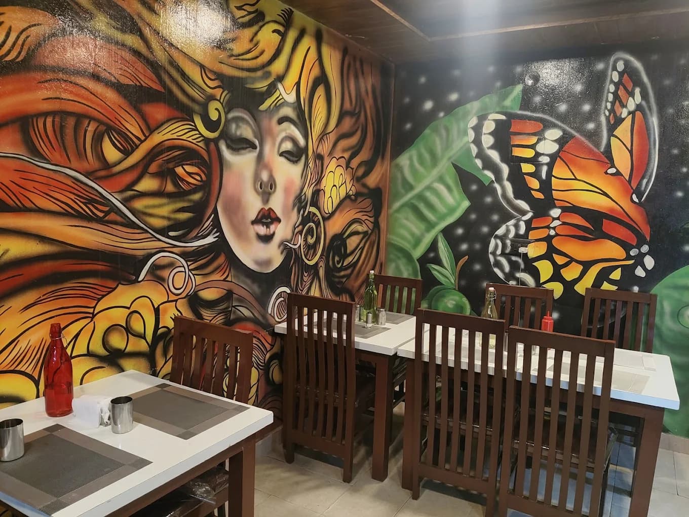 Colourful hand-painted mural beside the dining tables at Bharathi Kitchen